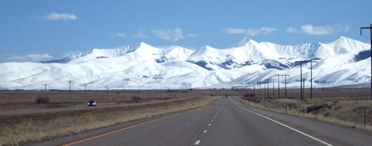 Road leading to snowy mountain tops